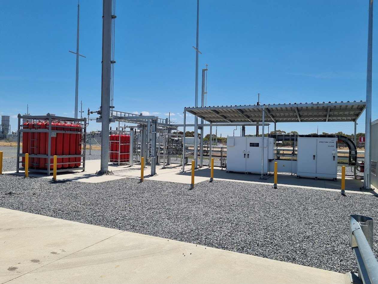 Bolivar hydrogen demonstration plant, with gas cylinder racks and equipment enclosures under a canopy