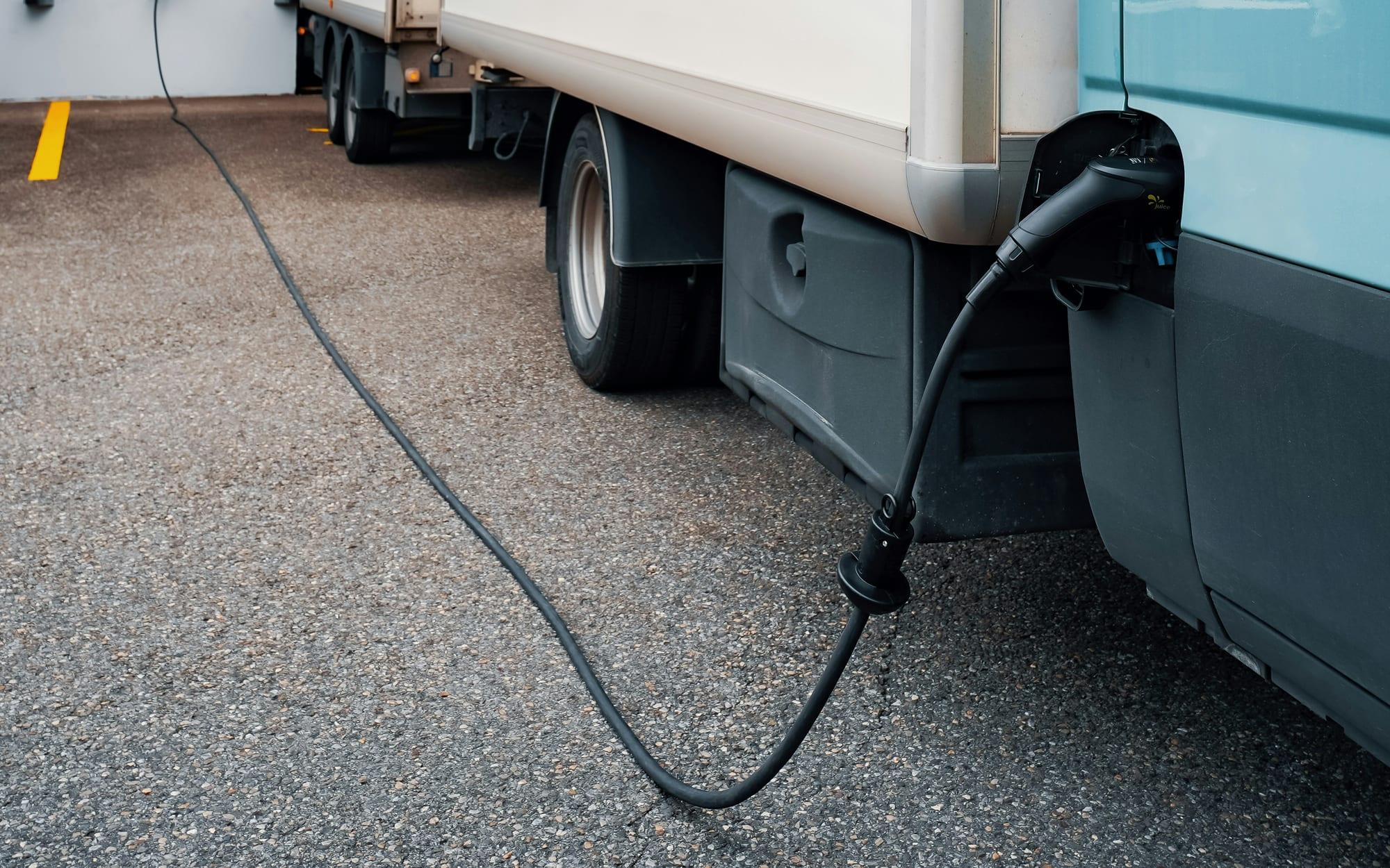 Electric truck plugged in to a charger